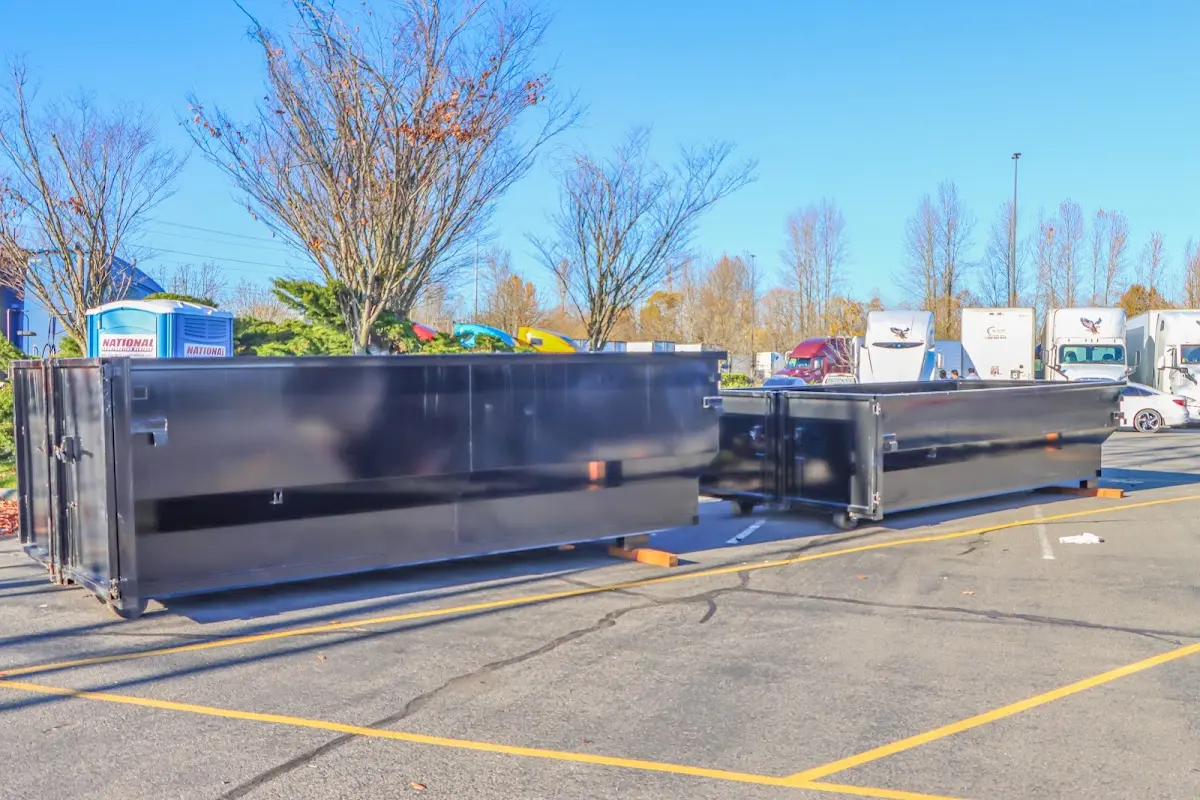 Professional dumpster rental service with roll-off container on residential driveway in North Hobbs